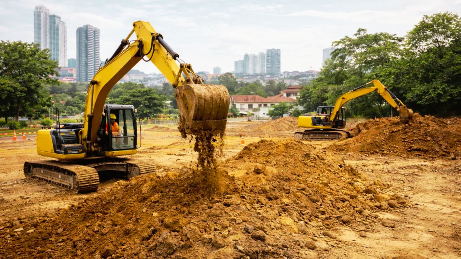 Bulldozer and excavator clearing a construction site before building begins.