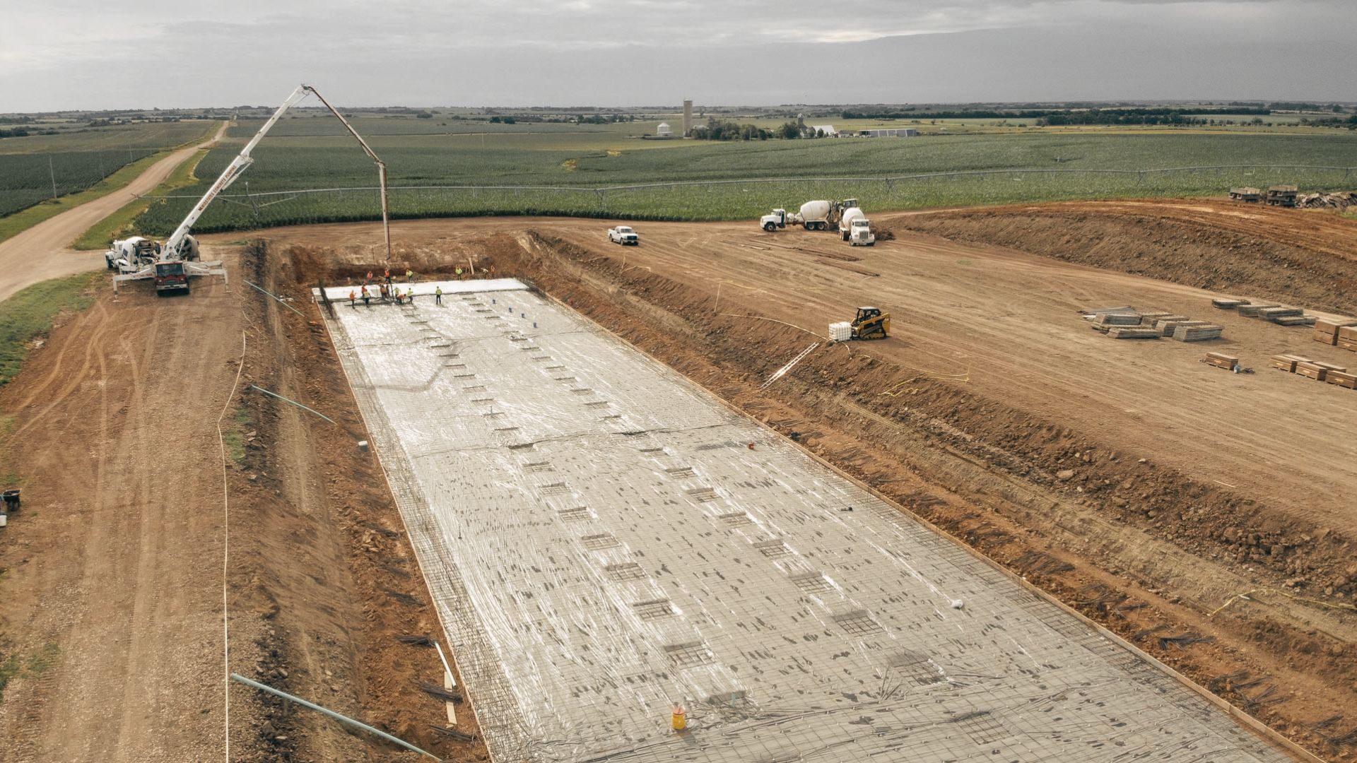 Utility installation and access road construction at a site.