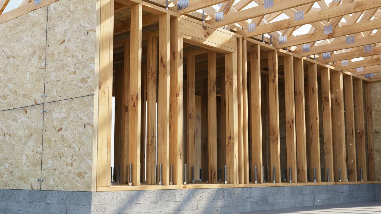 Timber load-bearing wall with wood studs supporting residential floors and roof framing.