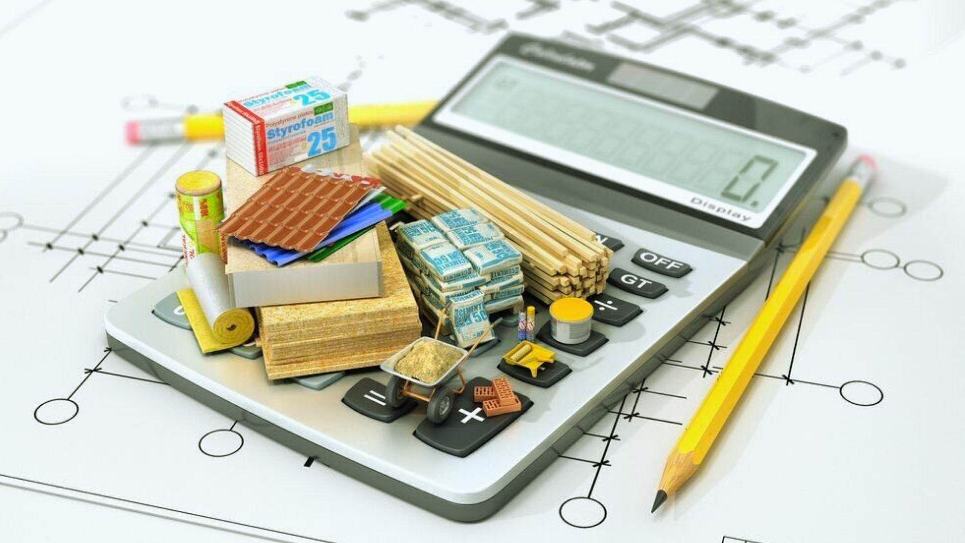 Construction cost estimation concept with building materials on calculator over blueprints