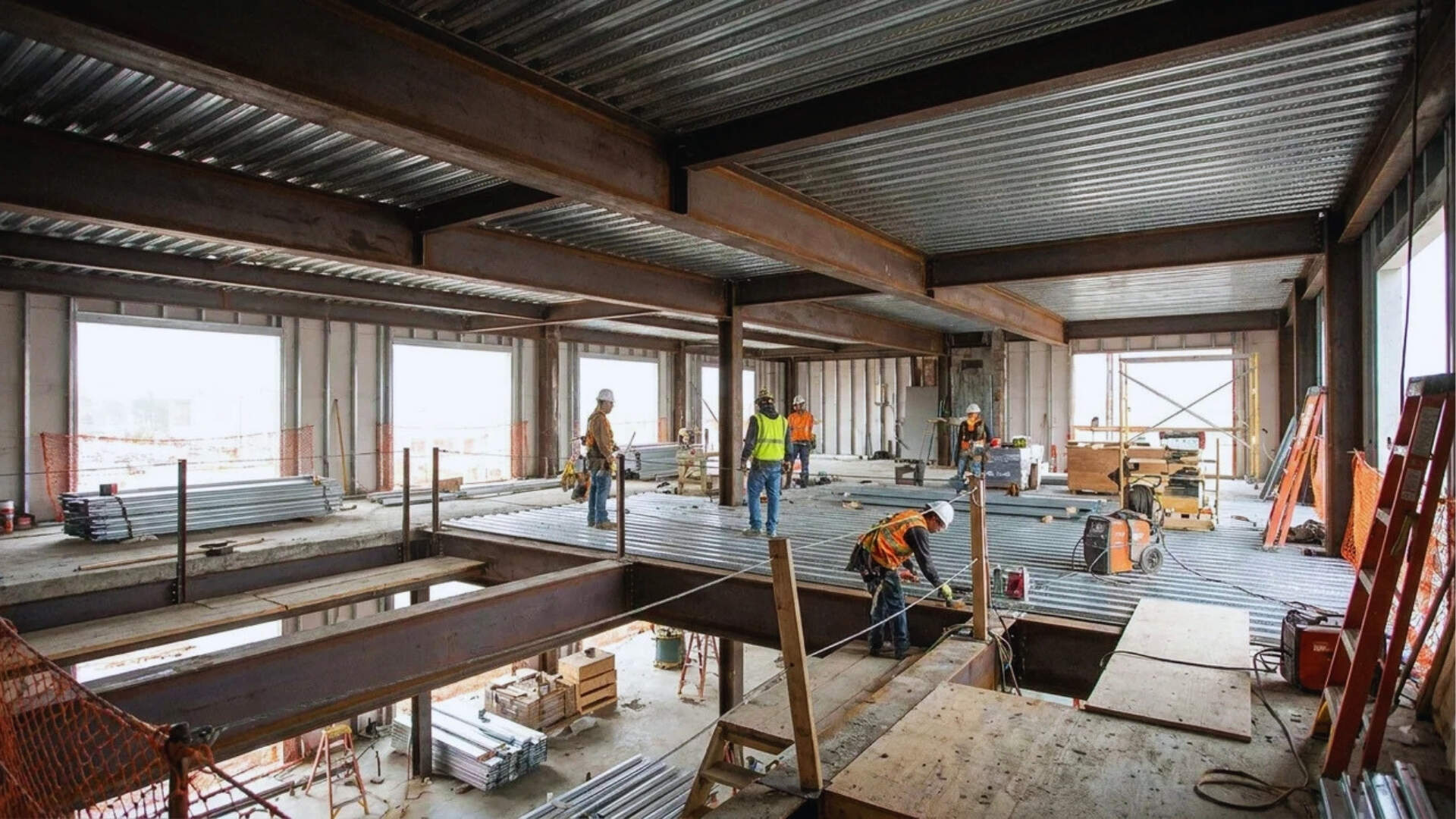 Steel beams and concrete floor deck inside commercial building.