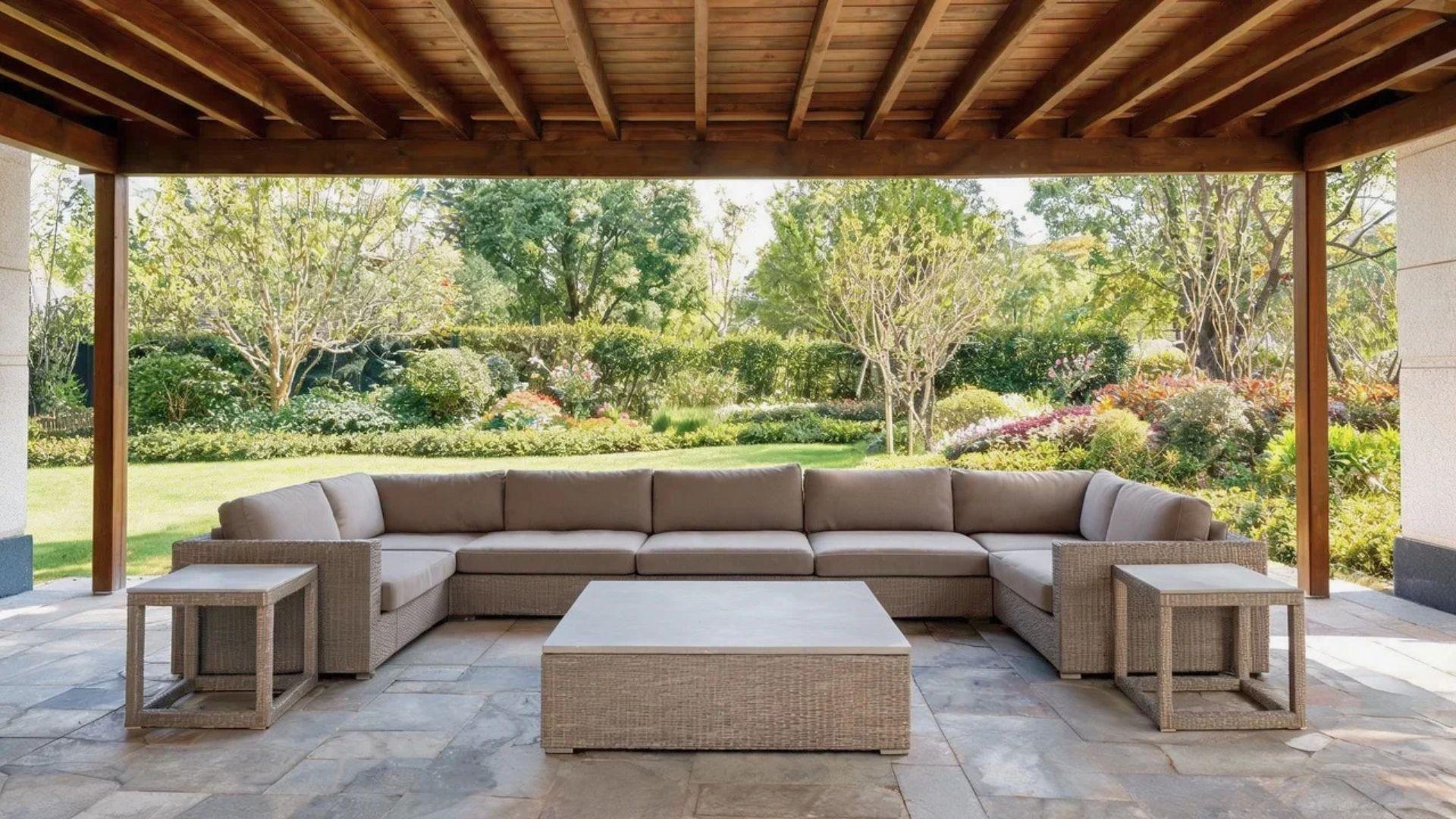 Outdoor sectional sofa and coffee table arranged beneath a covered patio.