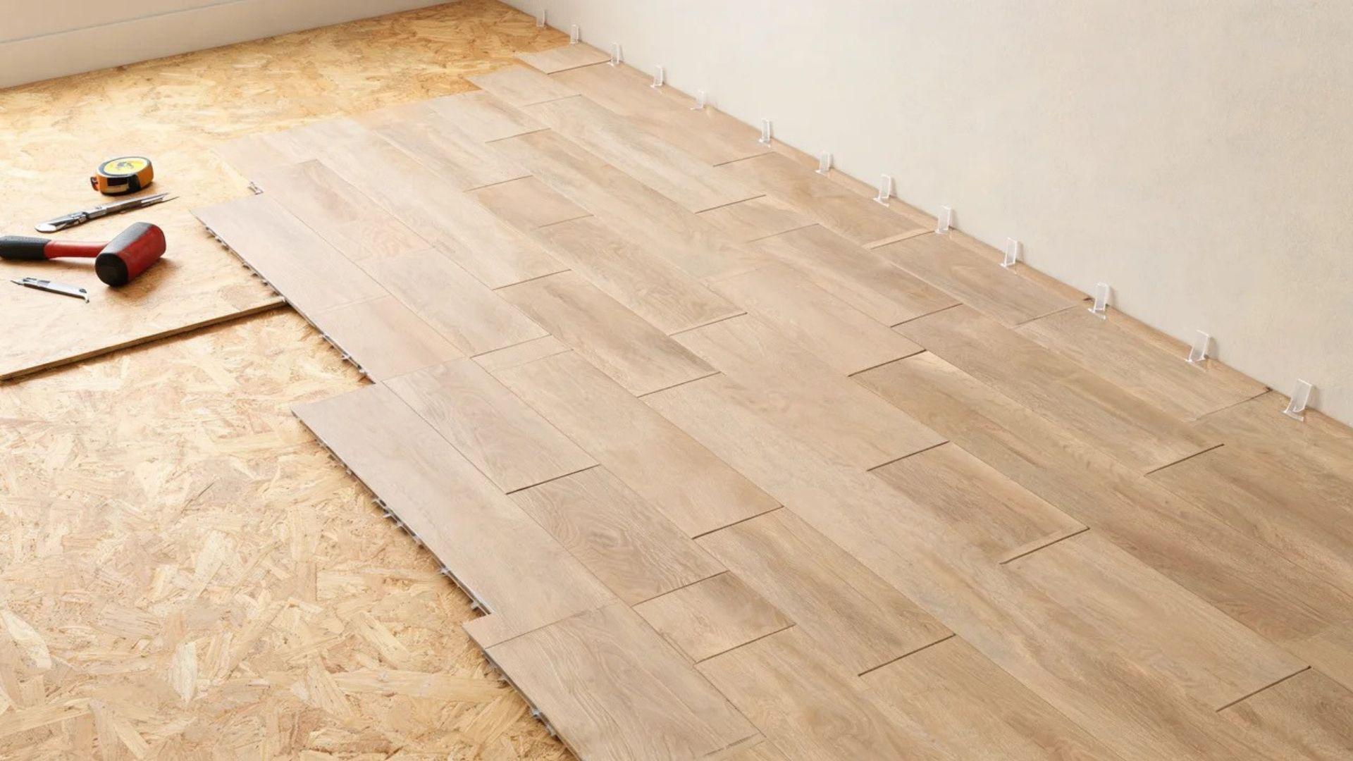 Staggered vinyl plank rows fitted together with spacers along the wall.File name: locking-vinyl-plank-rows