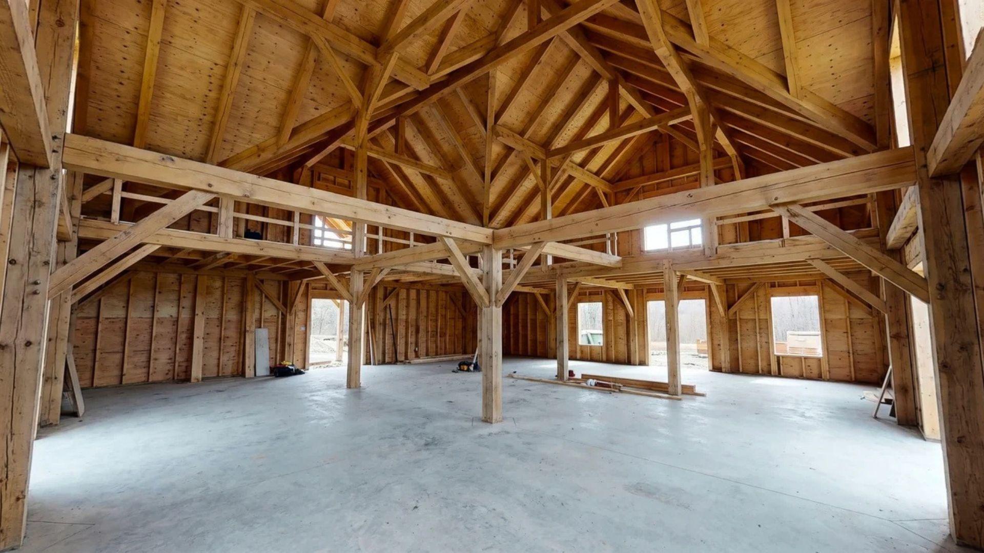 Heavy timber frame with exposed posts, beams, open interior space, and vaulted ceiling.