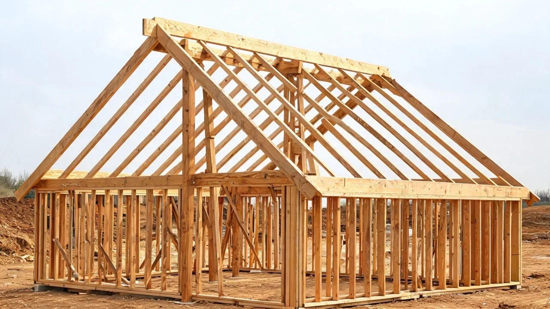 Gable shed roof framing with paired rafters meeting at a ridge board supported by temporary posts.