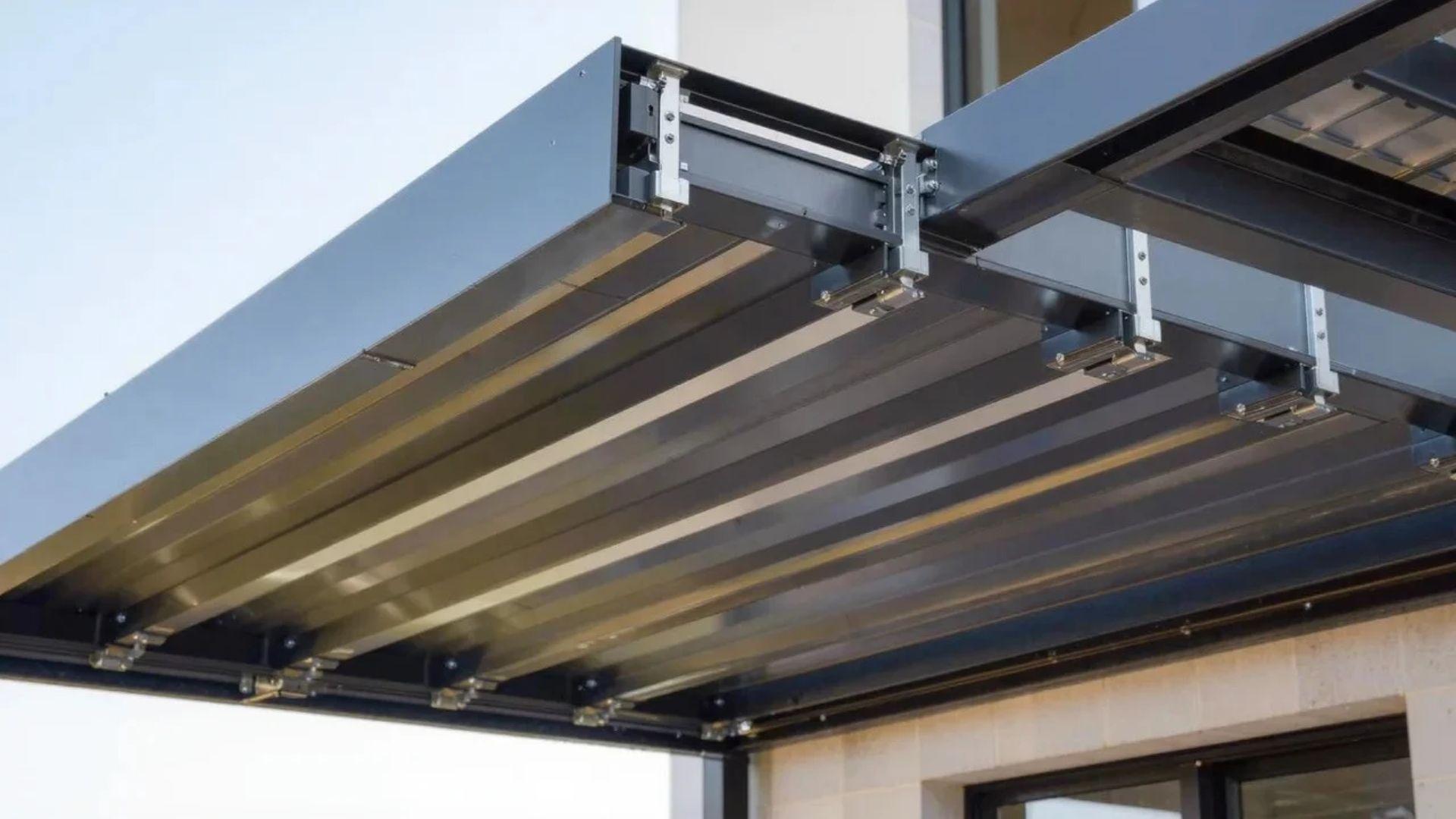 Louvered pergola with adjustable roof blades, support posts, motor housing, and integrated drainage gutters.