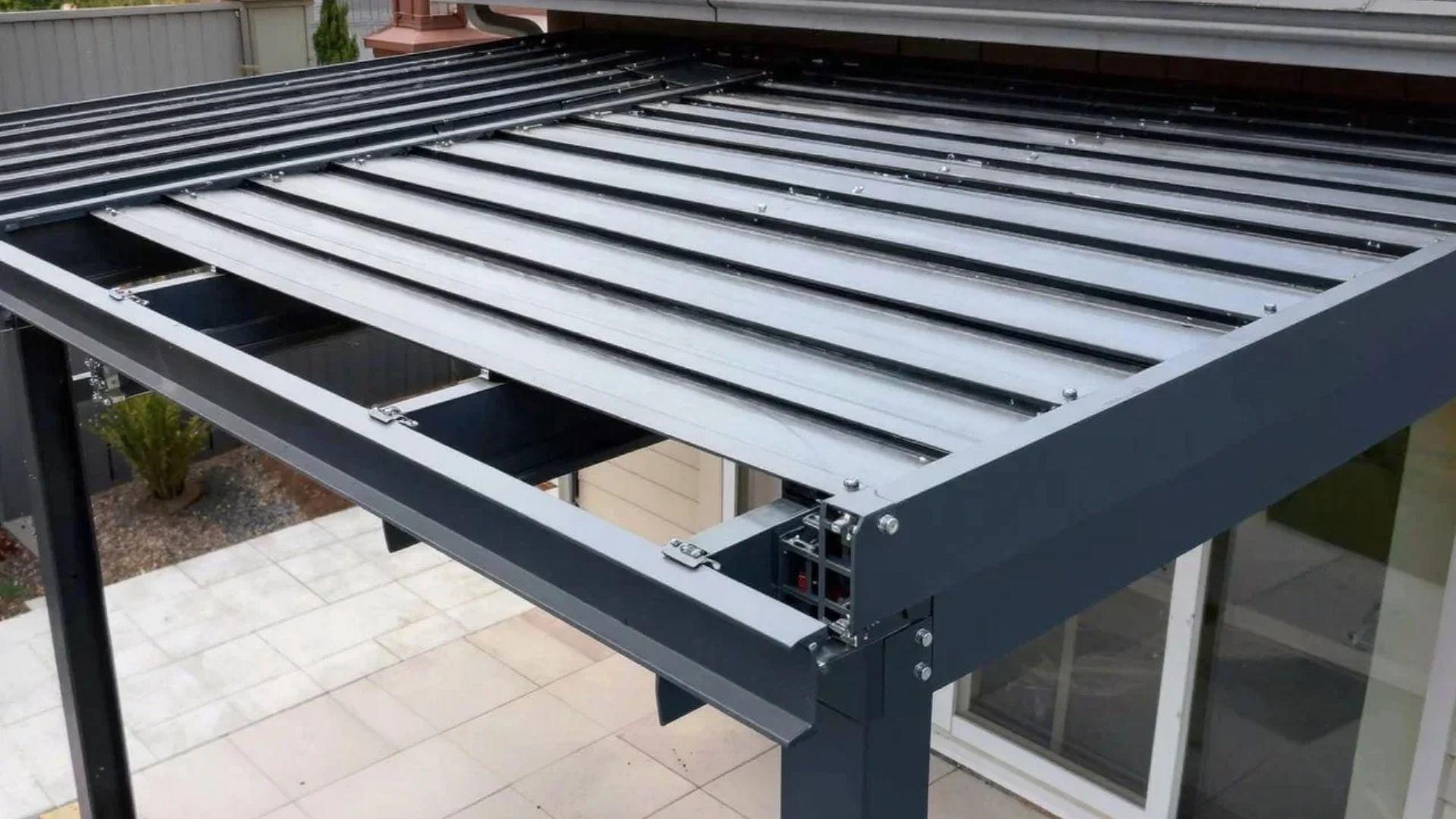 Closed louvered pergola roof showing adjustable blades, support beams, motor housing, and drainage channels.