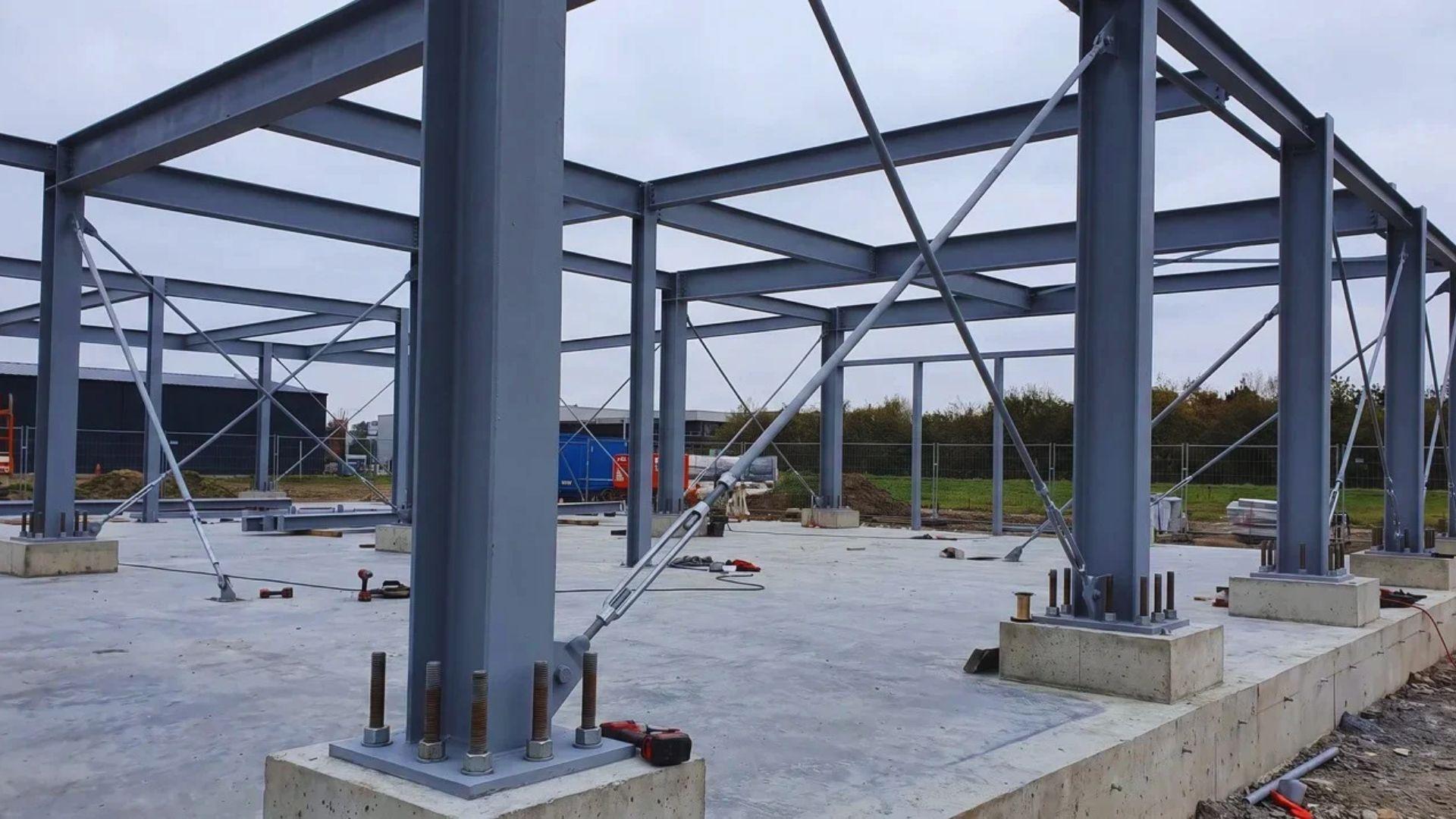 Steel columns anchored to a concrete slab with diagonal bracing between the frames.