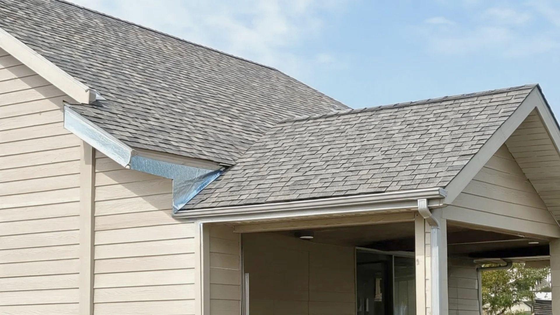 Sloped patio roof joined to the house roofline with metal flashing at the wall.
