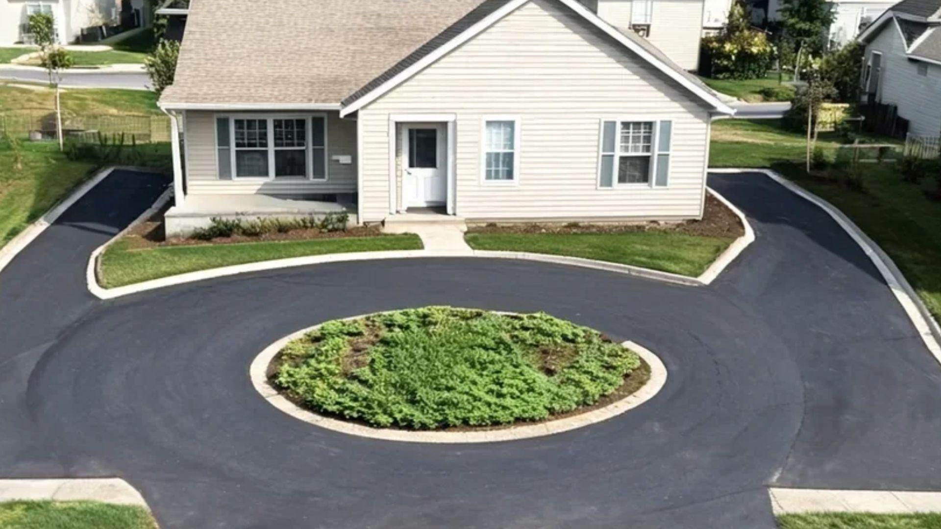 Compact horseshoe driveway with a small planted island in a narrow residential front yard.