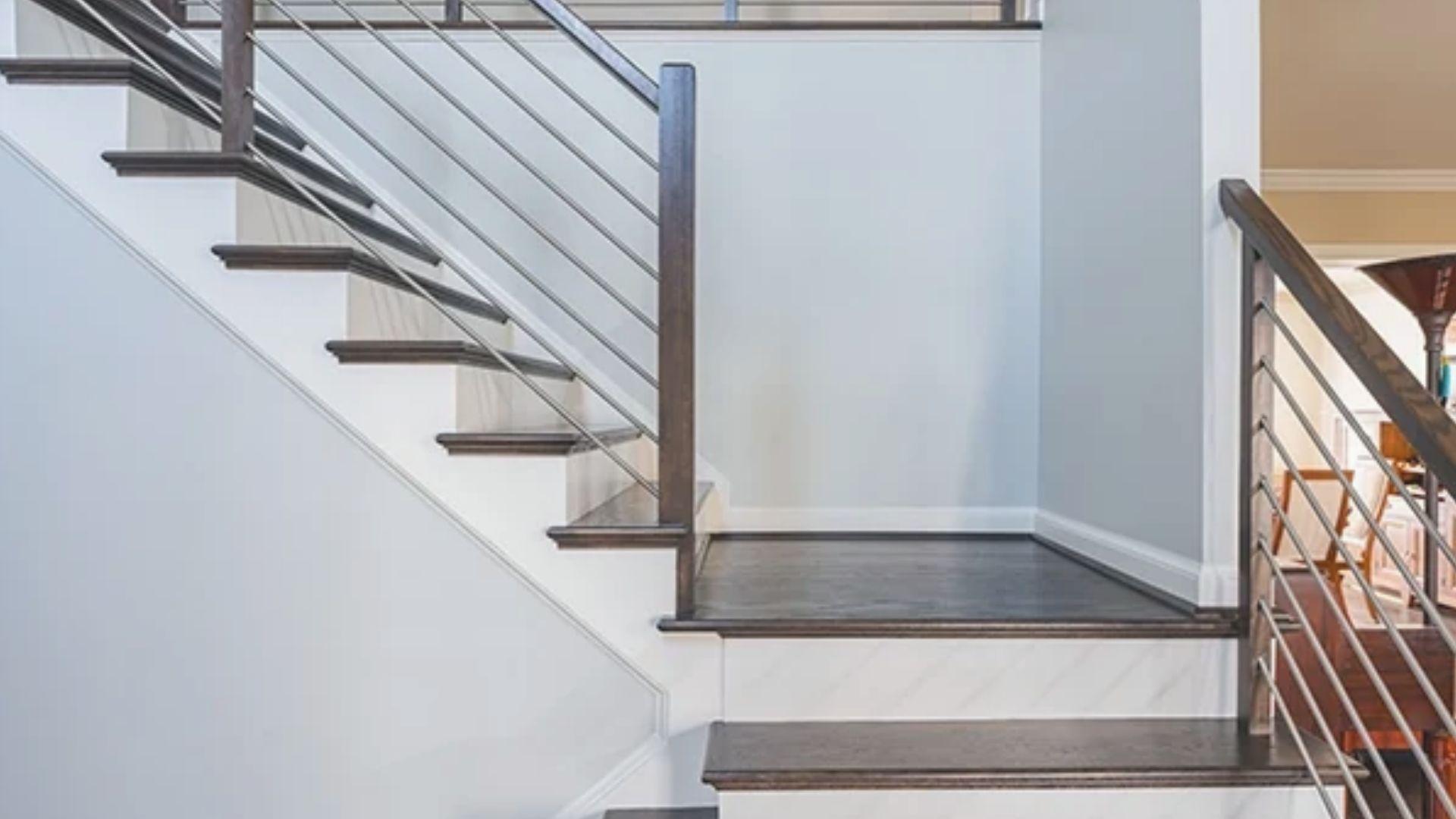 Wooden staircase landing connecting two flights of stairs at a turn