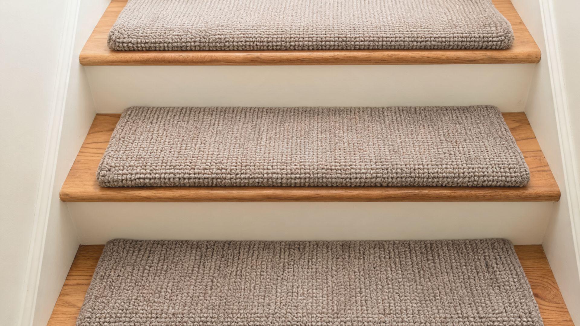 Solid-color ribbed wool stair runner covering the center of wooden stairs